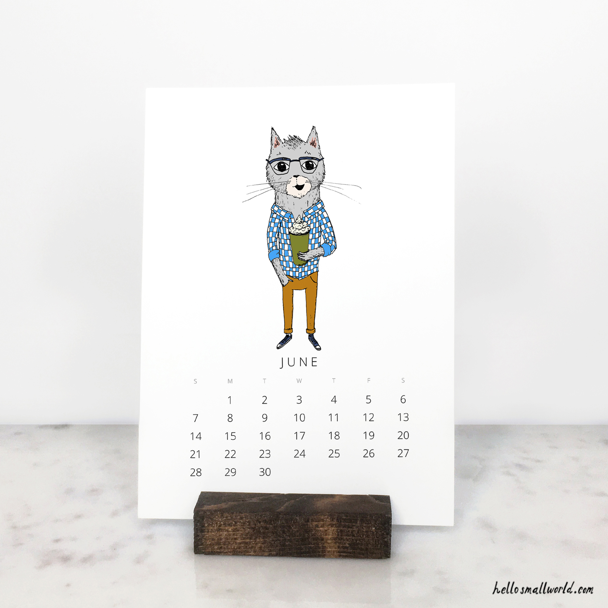 2026 calendar with wooden stand and cat for june